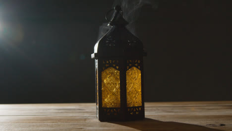 Stationary-Shot-of-Smoke-Pouring-Out-of-a-Lantern-During-Ramadan-Celebrations